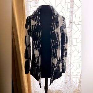 Cardigan sweater. Black and white knit button closure.